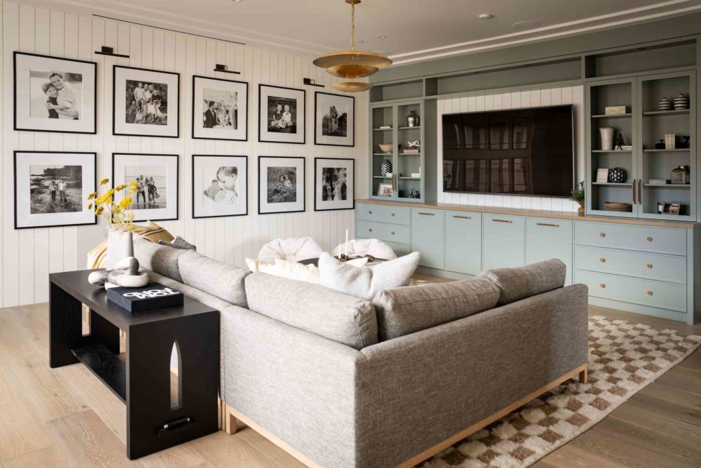i k z c a d caa d aff aaecf b f Chic living space with gallery wall and pastel cabinetry.