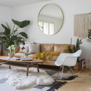 at house tours archive sunwoven f e c adffda deae bd baf Bohemian living room with 3-seater leather sofa and round mirror.