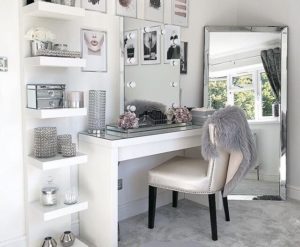 c d df b a be f Vanity corner decorated with flowers, brushes, and makeup essentials.