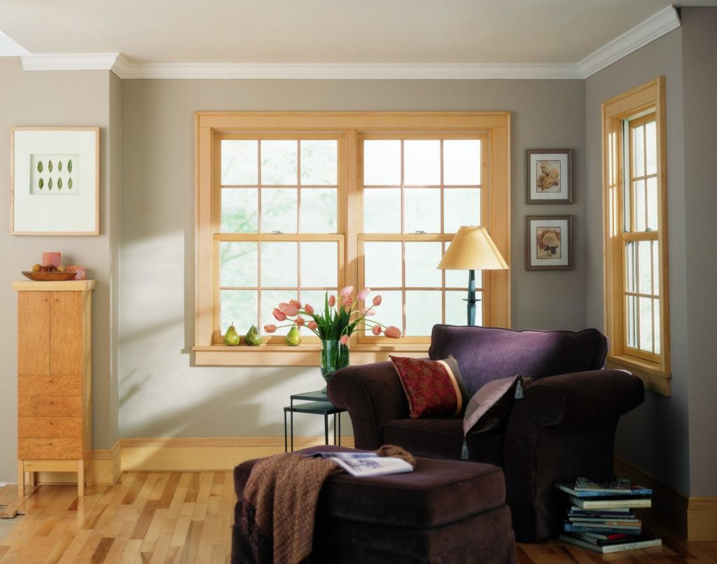 how to get more natural light x Cozy corner with armchair and floor lamp by window.
