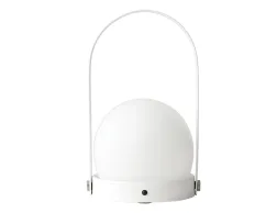 White Carrie Table Lamp with a round globe shade, circular base and tall arched carry handle