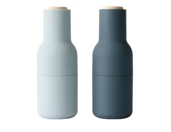 Audo Bottle Grinders in pale and dark blue with light wooden lids, shown from the front