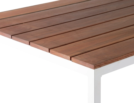 Close-up of the Cape Dining Table showing the grain and gaps between brown slats above a white corner frame