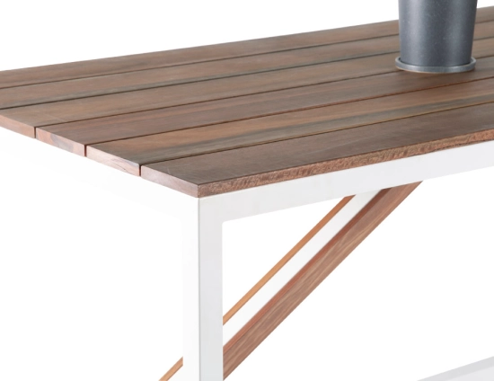 Close-up of the Cape High Bar Table showing brown slats, a white corner frame and diagonal brown brace