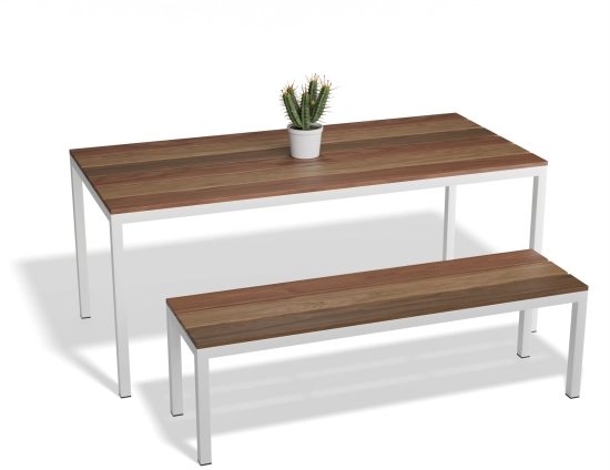 Angled view of the Cape Dining Table and matching bench with brown slats, white frames and a potted cactus