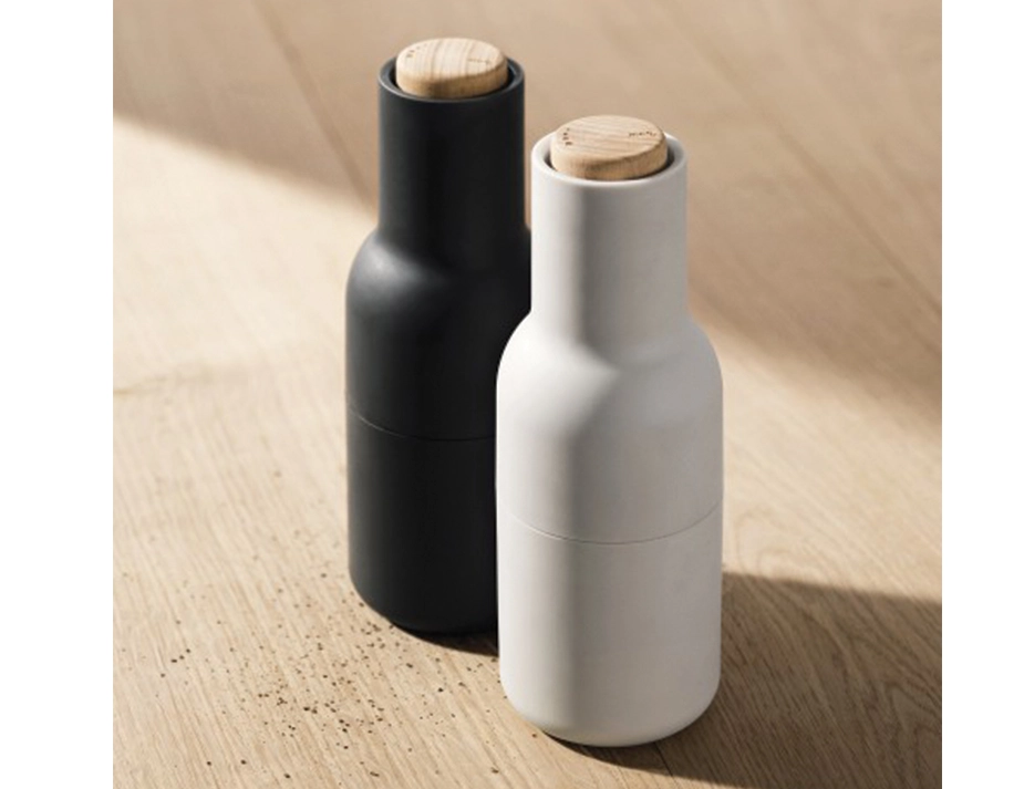 Elevated view of charcoal and light grey Audo Bottle Grinders showing their round wooden lids