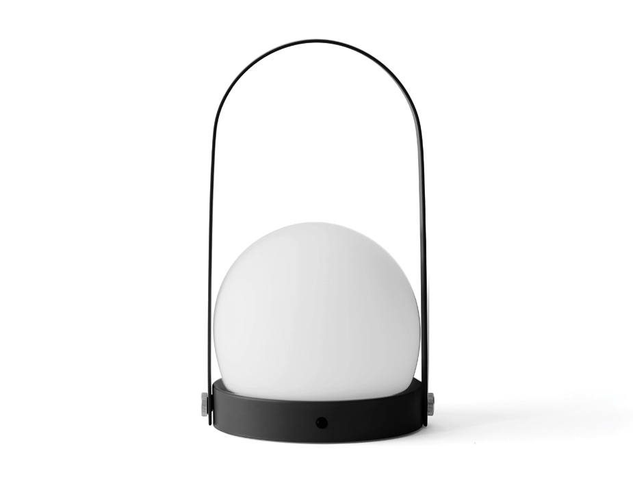 Black Carrie Table Lamp with a white globe shade, round base and tall arched carry handle