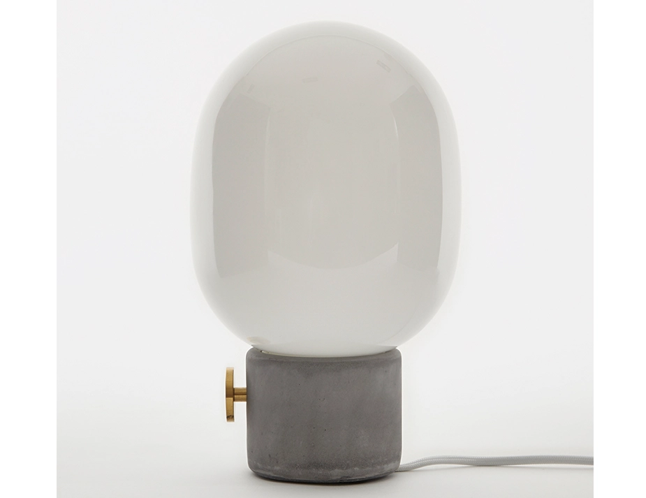 Side view of the JWDA Concrete Table Lamp showing its gold dial, grey base and white shade