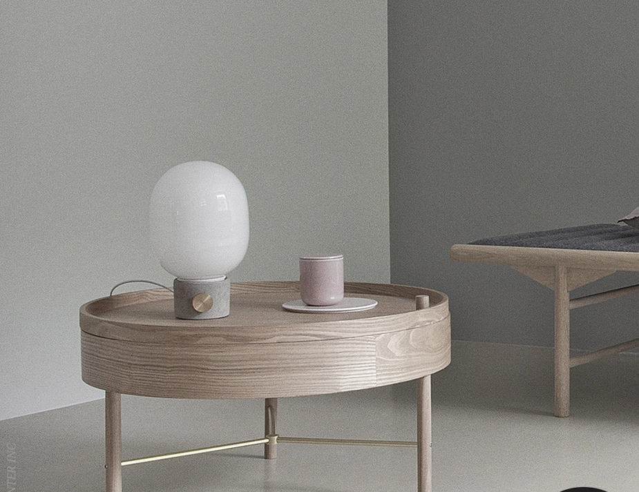 JWDA Concrete Table Lamp beside a pink cup on a round wooden tray table